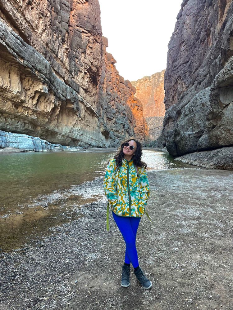 Me, a little chilly but cheering very big hiking the Santa Elena canyon. The land on the left is Mexico and the land on the right is the US!