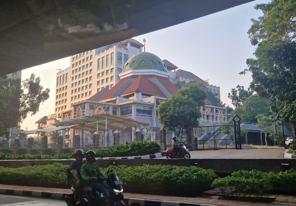 Sunset on mosque, viewed from under a road bridge.  Masjid Darul Jannah, Kantor Walikota, Jakarta