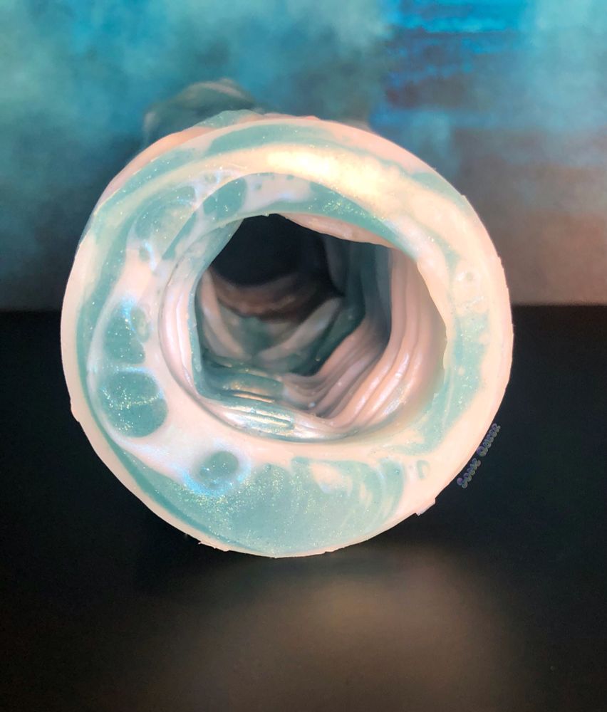 Dagon, silicone stroker pictured from the back, showing the ribbed tunnel.