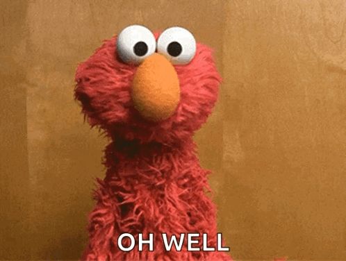 elmo from sesame street says " oh well " in front of him