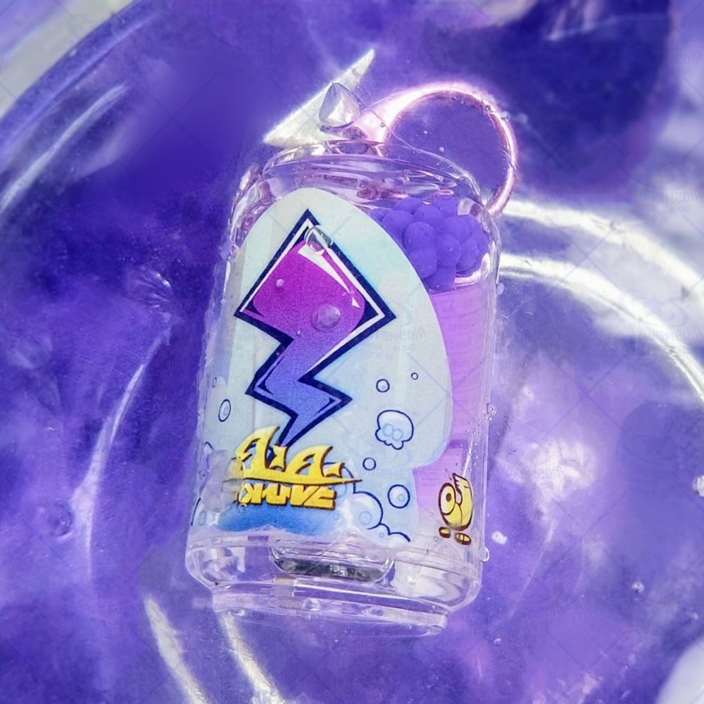 A picture of my merchandise - a transparent, liquid-filled keychain that resembles a Tacticooler from Splatoon 3 - floating in a clear bowl of purple water