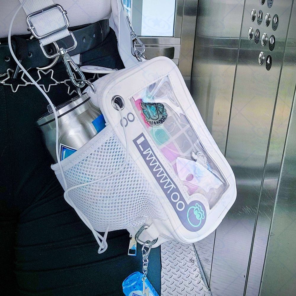 My Essentials Ita bag in the Side Order variant. It's hanging off a person's side like a crossbody bag, holding a Tacticooler cup in a mesh pocket and an earbud cord through a grommet. The picture is taken inside an elevator.