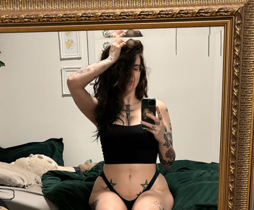 mirror selfie witchytq black attire holding her hair up