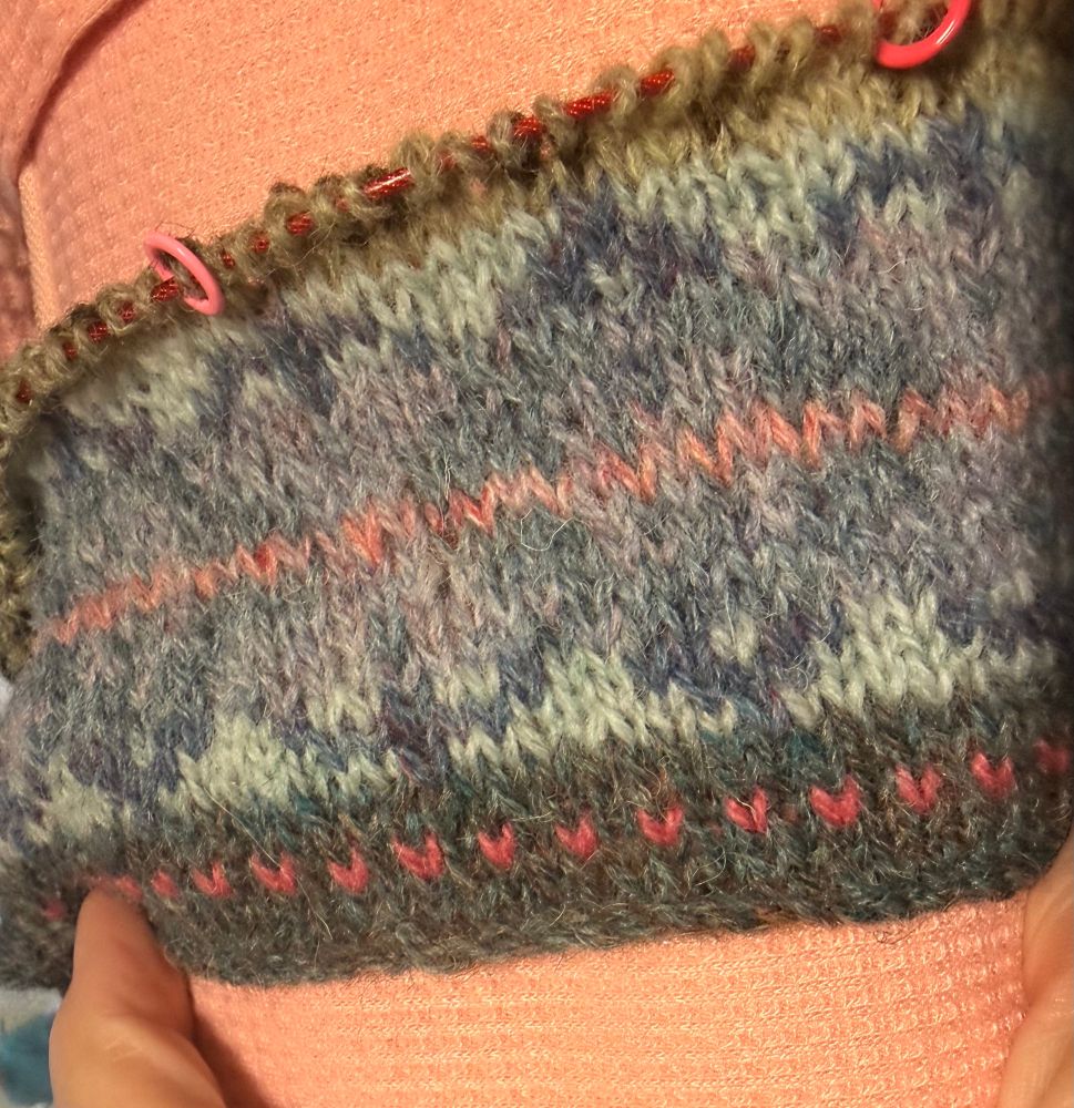 Fair Isle sweater, first motif in shades of green, blue, and pink. 