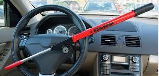 The Club anti-theft device attached to a steering wheel