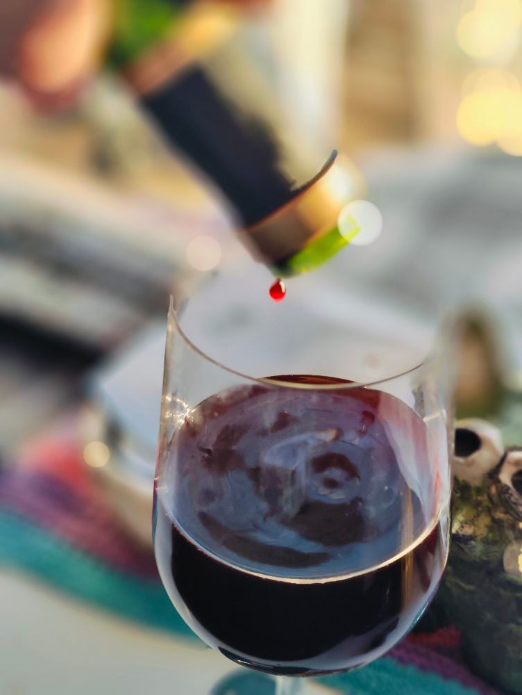 Last drop of wine leaving the bottle.