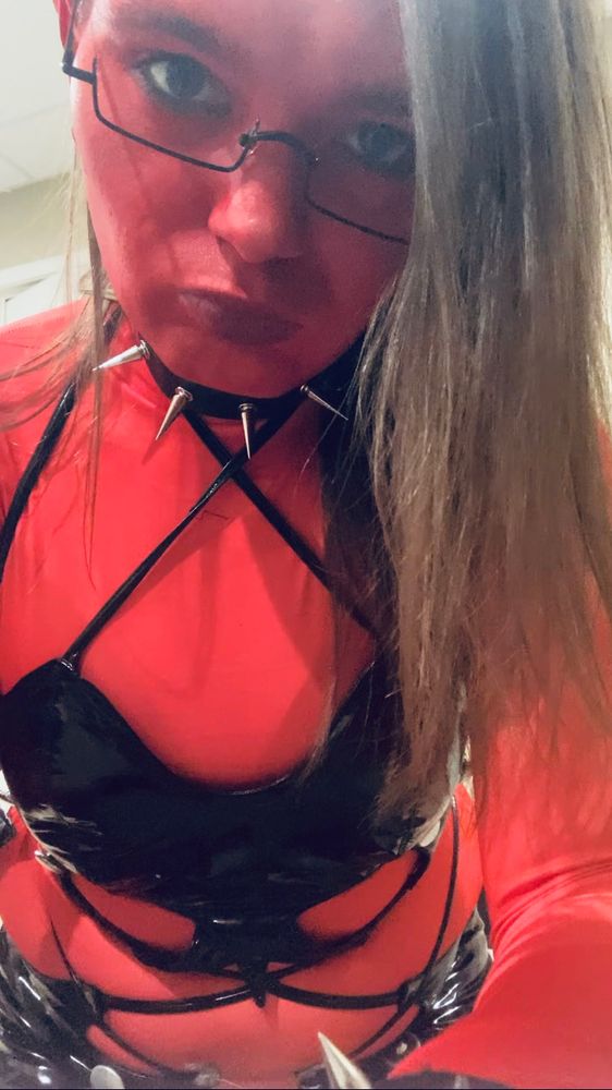 A closeup shot of myselffrom the bust up, showing my spiked choker and glasses on the red demon costume.