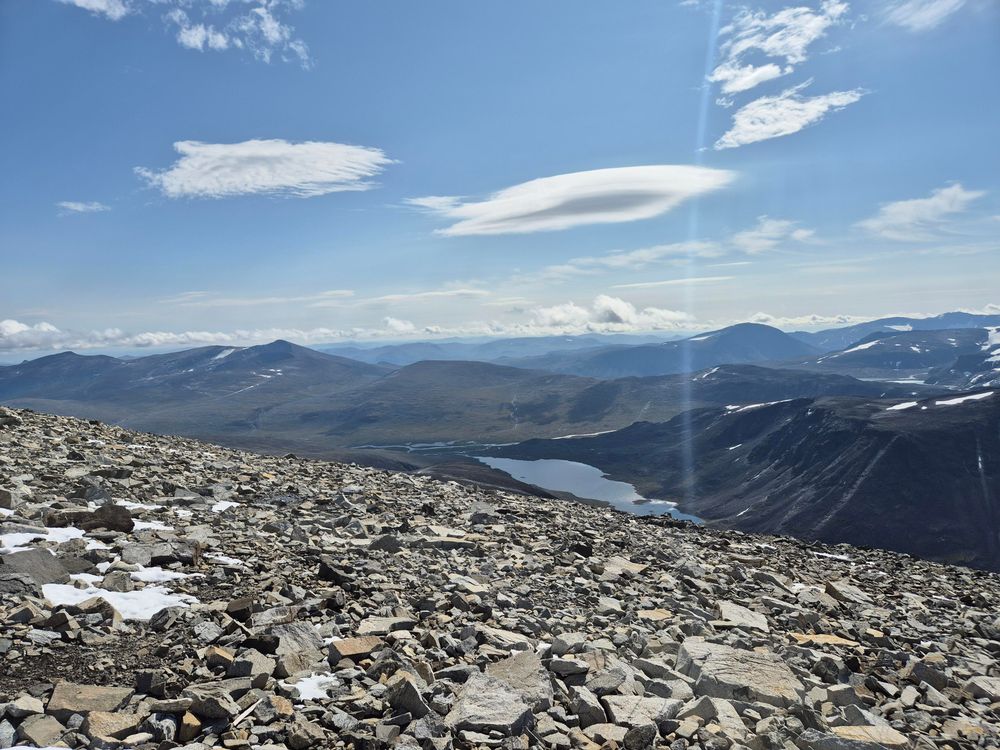 a view of the mountains to the east of Glittertind from the peak of Glittertind, with the valley between visible and Nedre Steinbuvatnet below Ryggjehøe