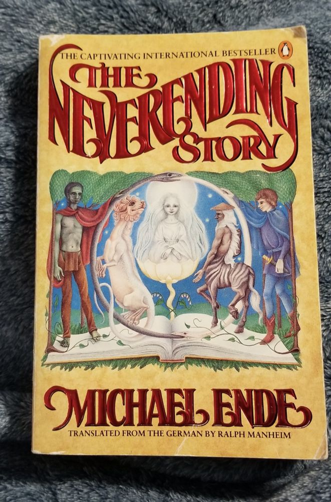 The Neverending Story by Michael Ende. Illustrated characters on an open book.
