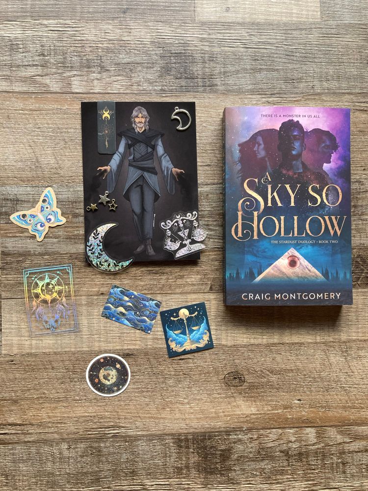Wood panel background, the book A Sky So Hollow, with character art, astrology themed stickers and charms. 