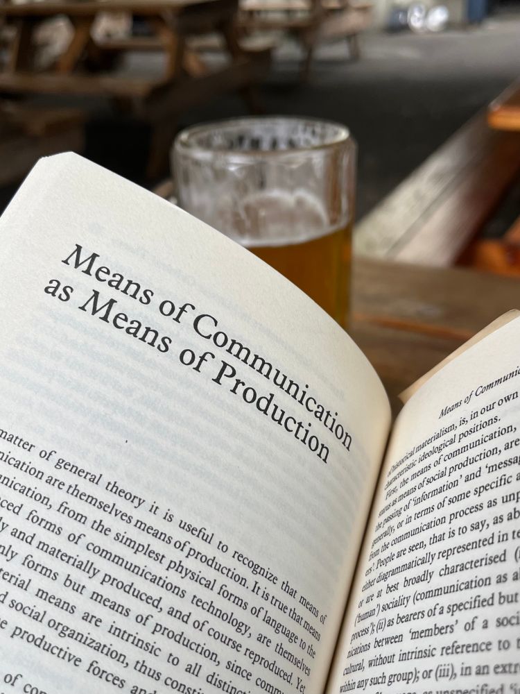 Photo of an open book, the chapter reads: means of communication as means of production. From Raymond Williams’ Culture and Materialism