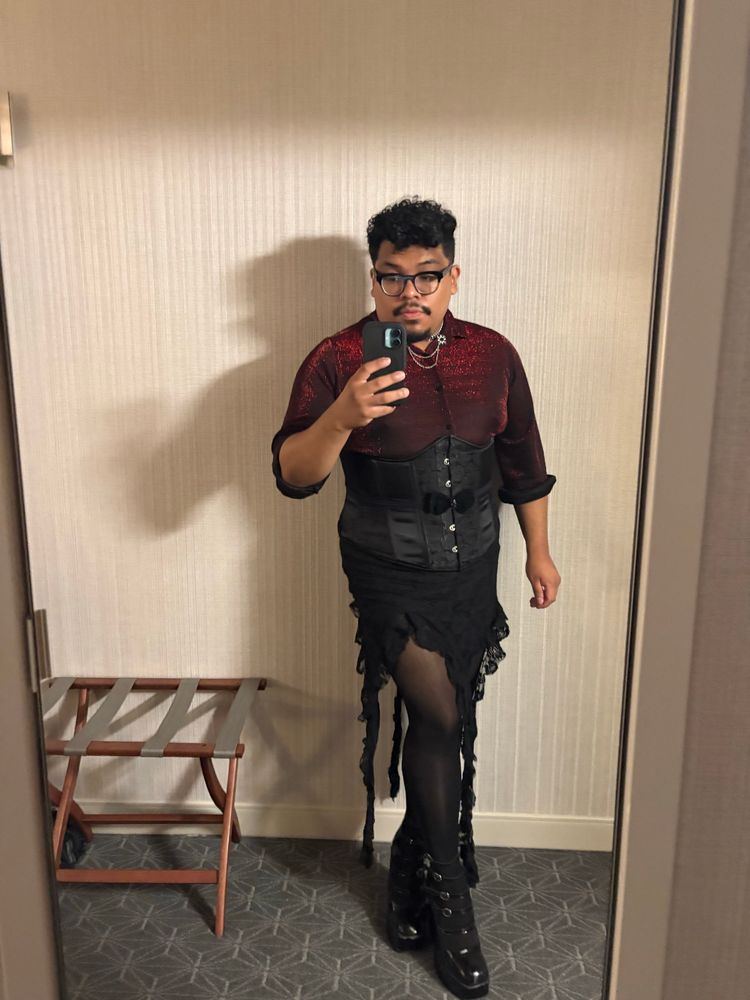Me in a red dress shirt with a corset and a black skirt with tendrils. Also wearing some fun heels.  