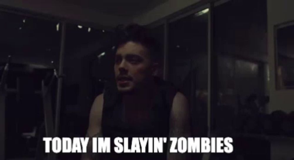 a man says " today im slayin ' zombies " in a dark room