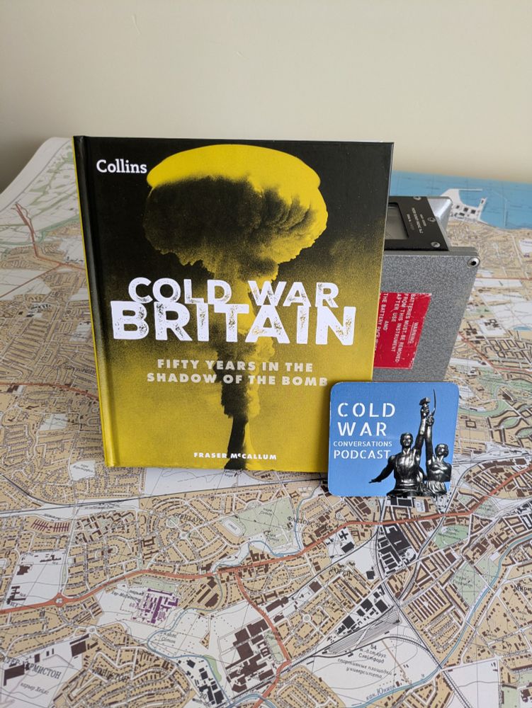 Trying to be arty. My competition win copy of "Cold War Britain" by Fraser McCallum.
It is propped up by a British "Meter Radiac Survey No2" (early cold war British radiation meter). Propped against the book is the "Cold War Conversations" coaster.
All 3 items are placed on top of a reprint of a Russian Cold War Map of Edinburgh from "The Red Atlas".