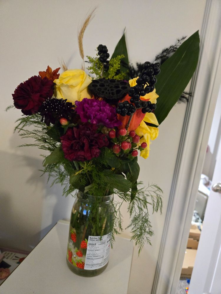 A gorgeous and striking bouquet full of black, yellow, and red flowers ~