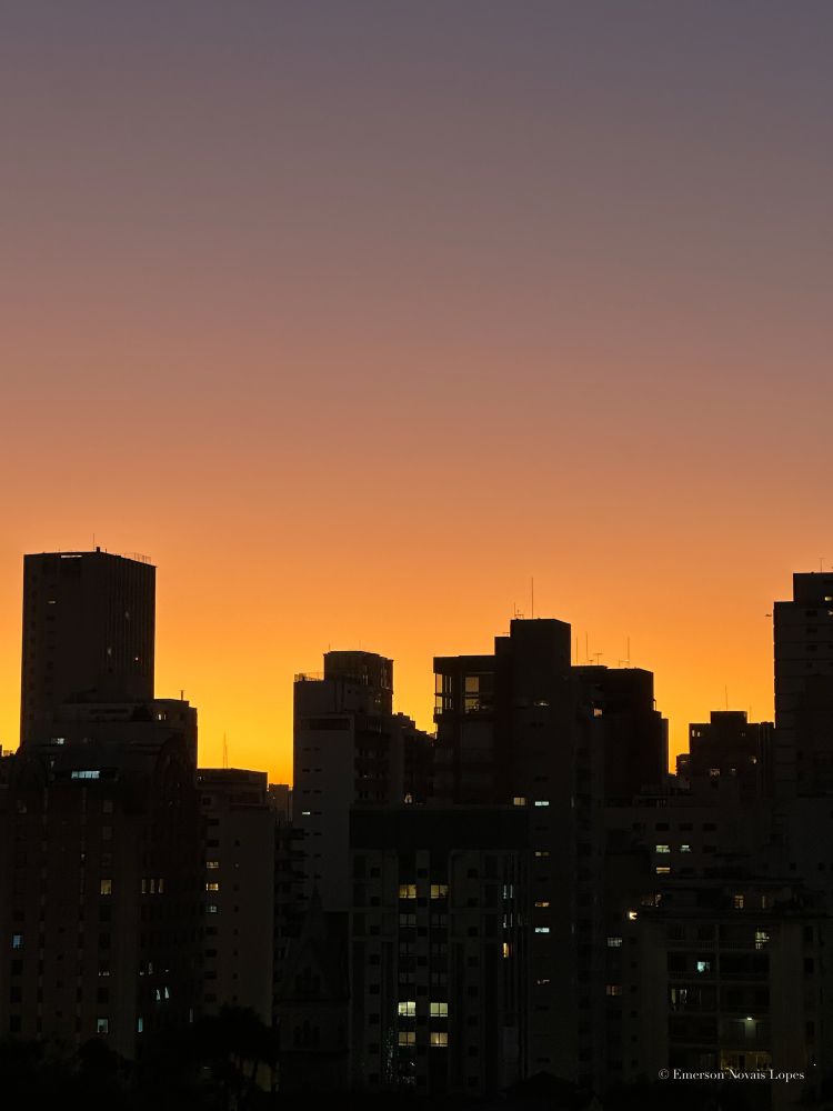 Photography. Color. Cityscape with a skyline of building silhouettes against the orange sunset. Downtown São Paulo, Brazil.