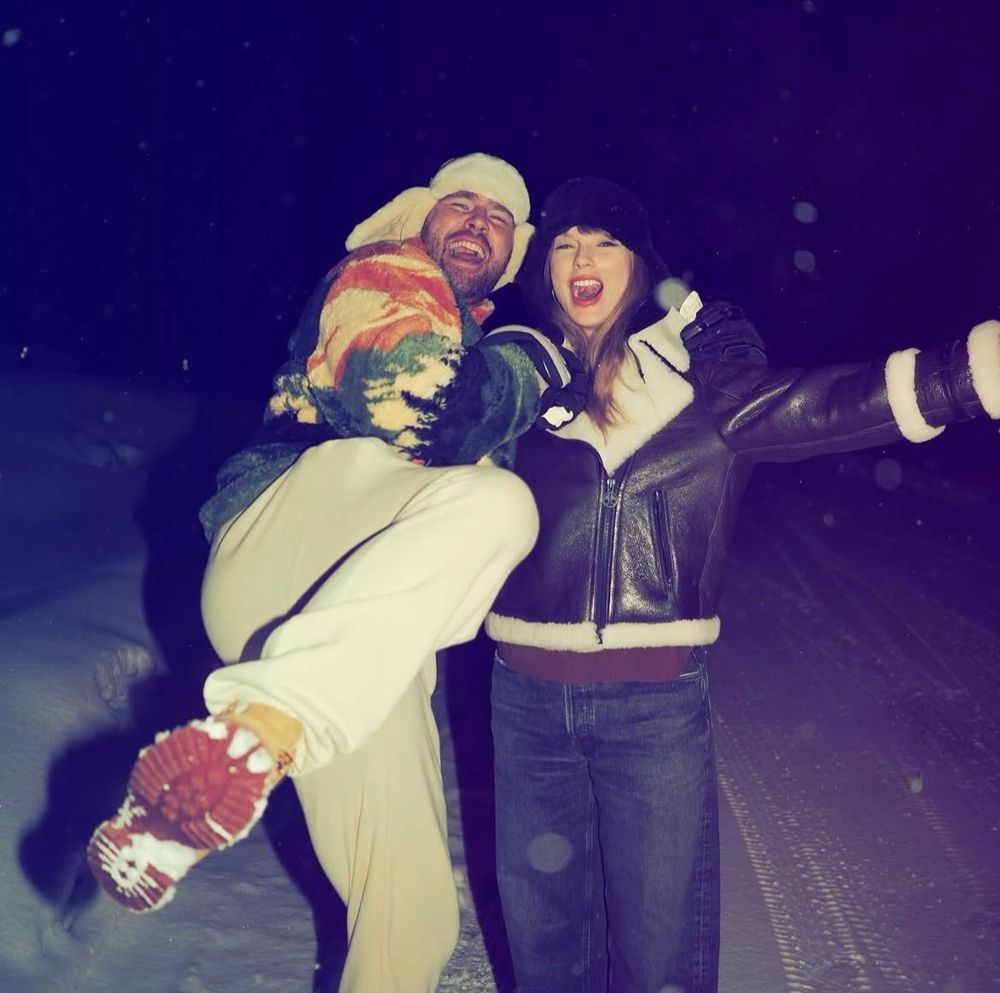 Taylor Swift and Travis Kelce playing in the snow at night 