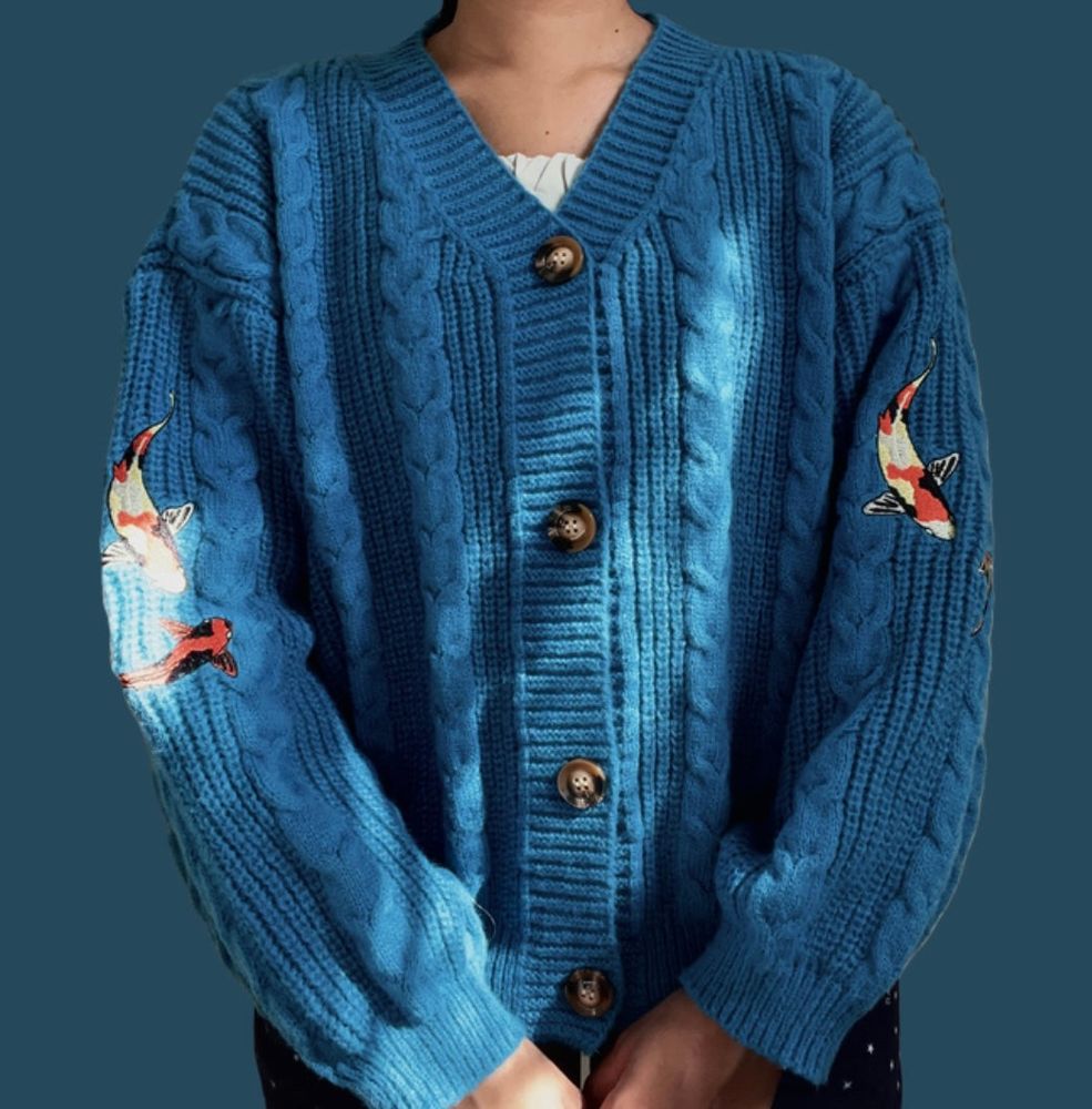 blue cardigan with koi fish embroidered on the sleeves, inspired by taylor swift’s album: speak now.