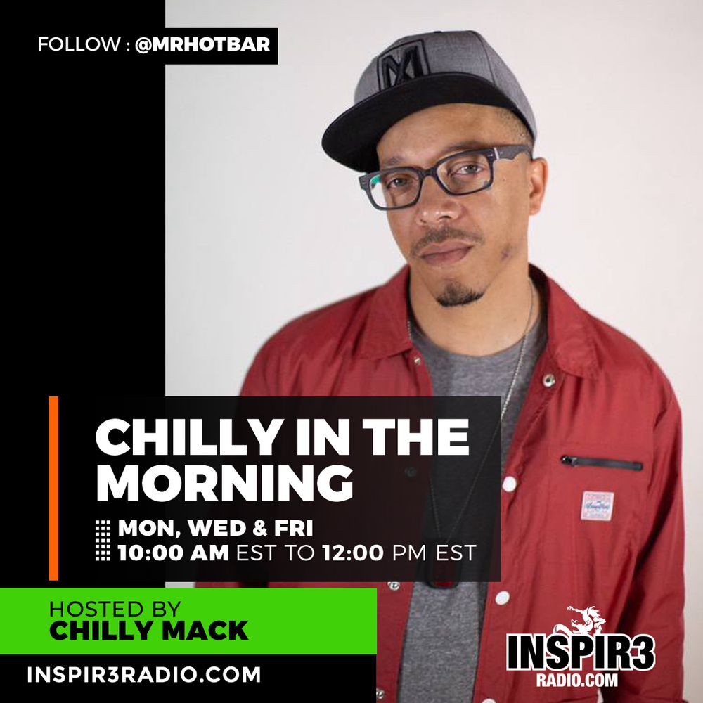 A man with glasses looks at the camera with an intense look. 