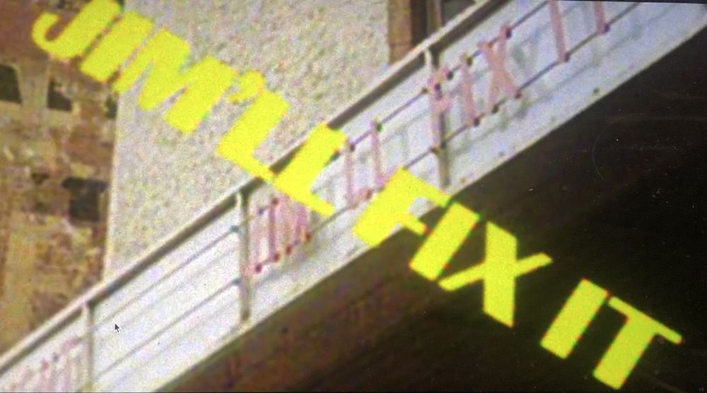 Screenshot from the documentary with the words JIM’LL FIX IT splashed across the screen