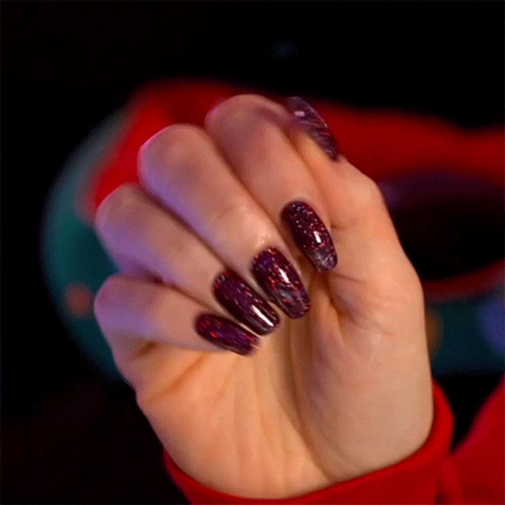 a close up of a woman 's hand with a red sweater on