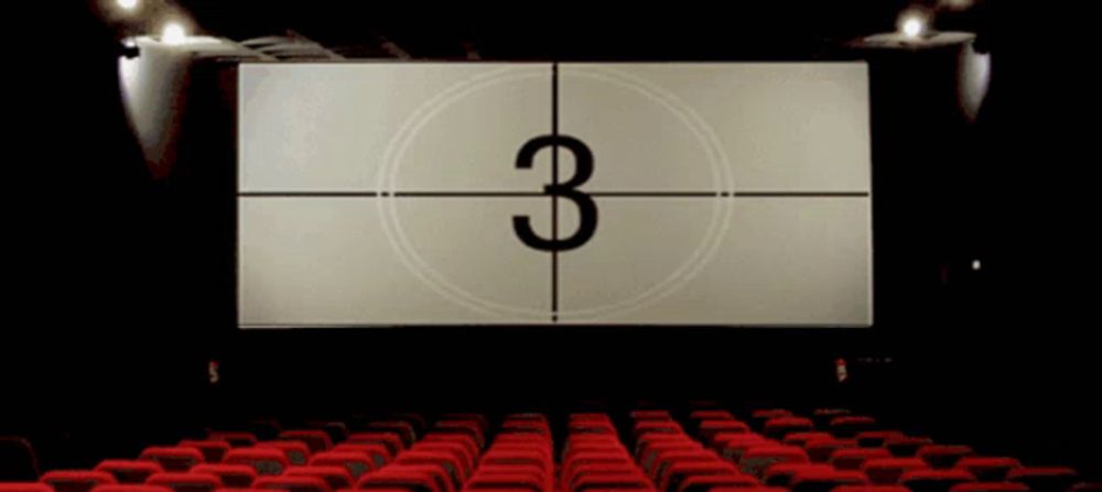 an empty movie theater with a countdown clock showing the number one