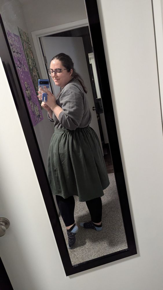 Showing off the modified back of the pleated skirt, showing that it's elastic