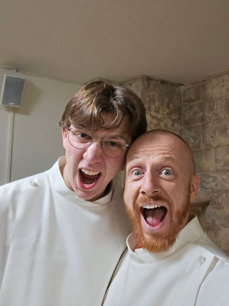 My son and I dressed in server's robes,  pulling madly excited faces!