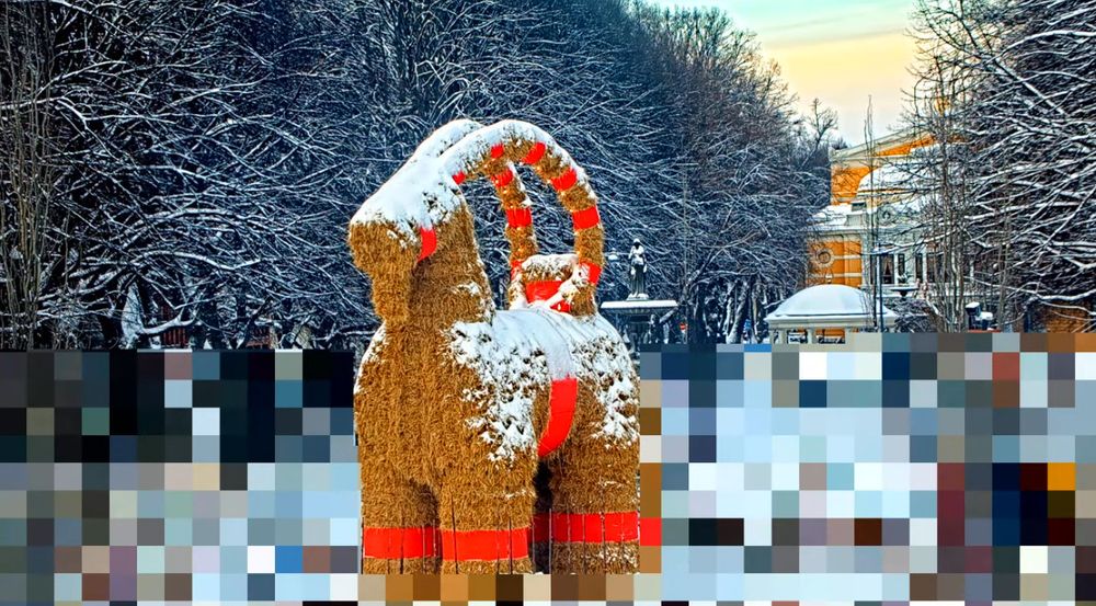 Screenshot of the Gävlebocken webcam on visitgavle.se. It's daytime and the trees and city, as well as the Bock himself are covered in a small layer of snow.