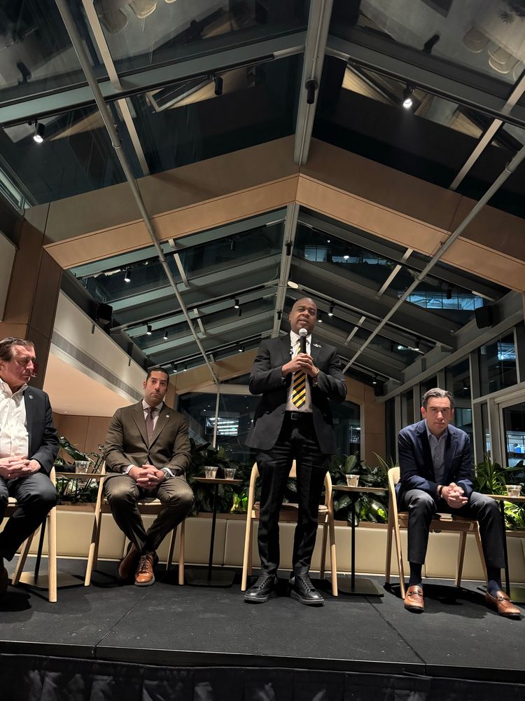 Mayor Ras Baraka speaking on stage at the Central New Jersey Democratic Gubernatorial Candidates forum. Sitting on stage are Mayor Sean Spiller, Mayor Steven Fulop, and State Senator Burzichelli on behalf of the Sweeney campaign. 