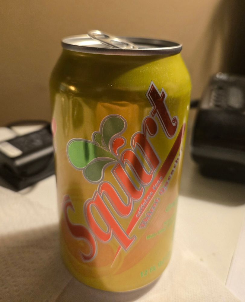 A yellow soda can labeled 'Squirt'