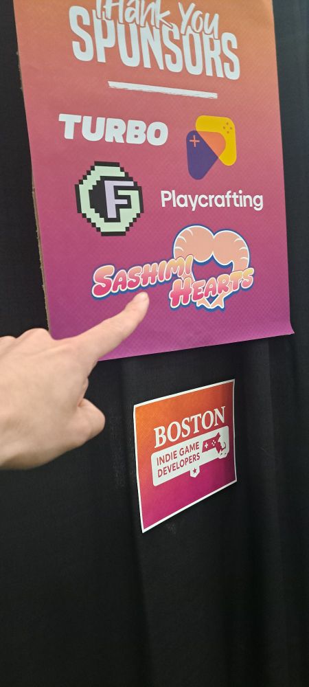 Photo of my hand pointing at my game's logo on a sponsor list for PAX east