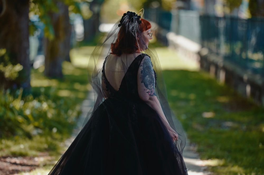 The same woman standing outside, shot from behind