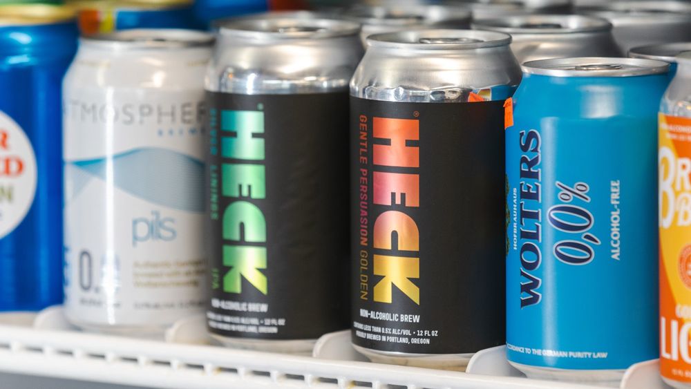 Two cans of Heck non-alcoholic beer in a beverage fridge