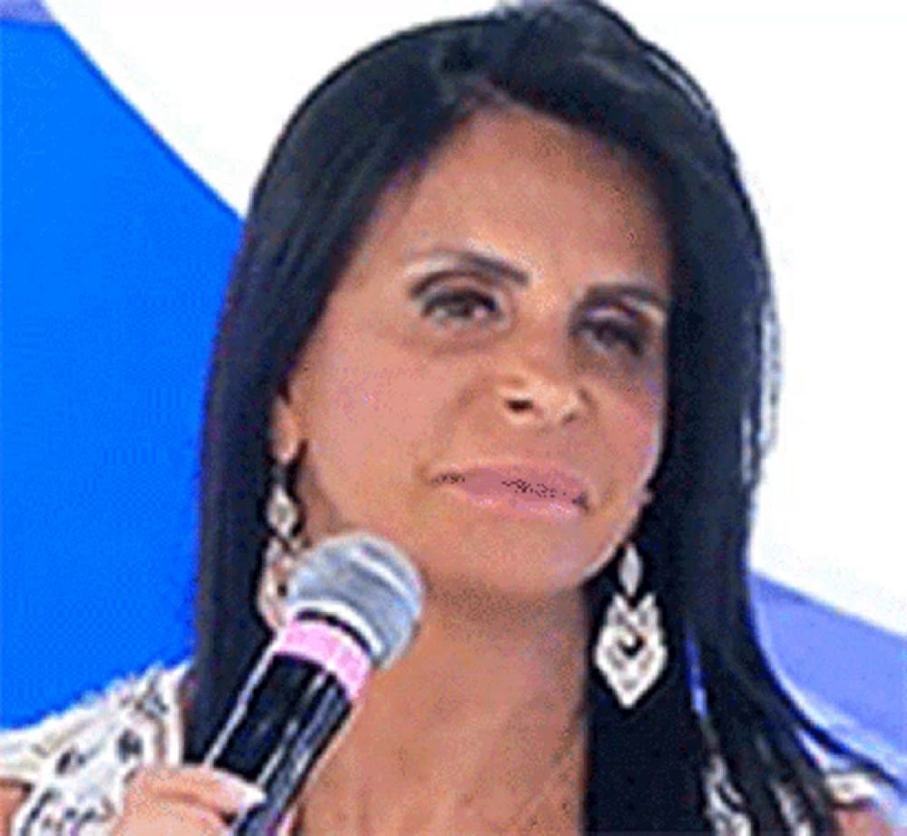 a woman with long black hair is holding a microphone in her hand .