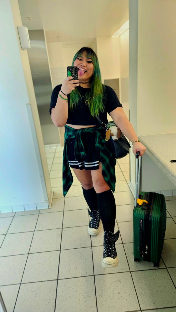 Girl in airport bathroom with luggage