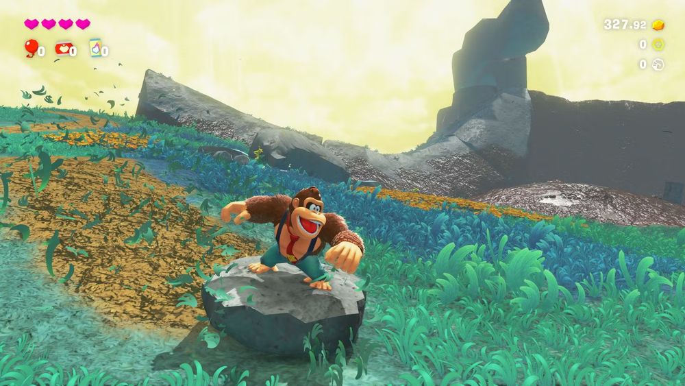 Screenshot af Donkey Kong Bananza - Donkey Kong surfer på et stykke sten han har revet af klippen.