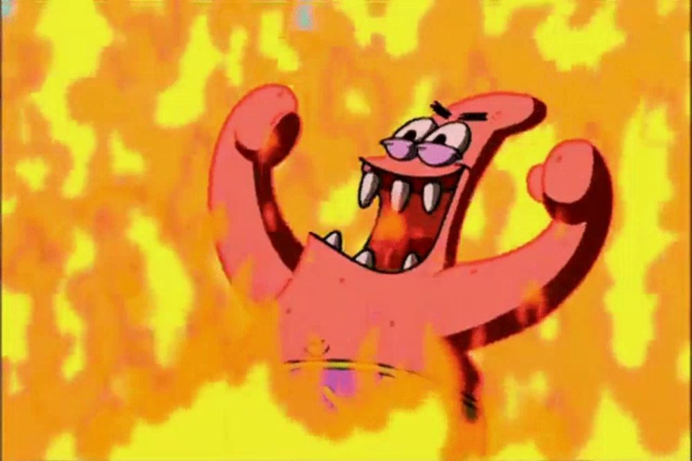 patrick star from spongebob squarepants is standing in the middle of a fire with his mouth open .