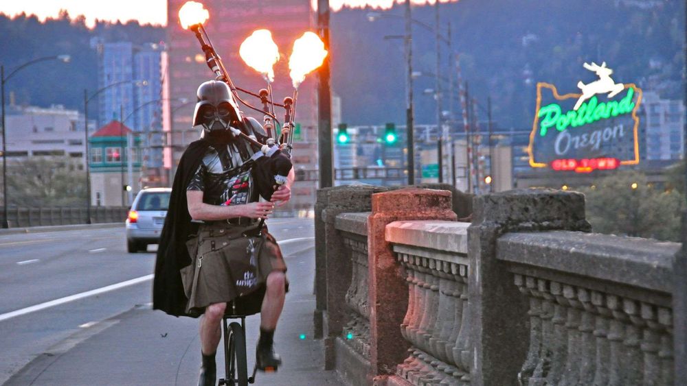 Portland's Unipiper: a unicyclist, dressed in kilt and darth vader cape/helmet, playing bagpipes where the drones spout flames.