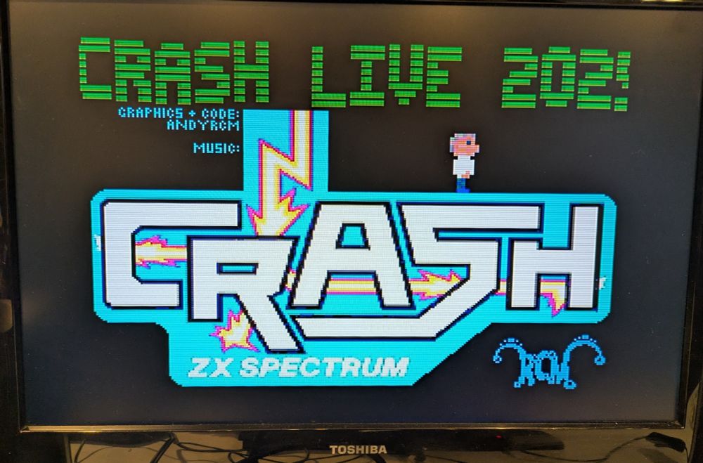 Photo of a ZX Spectrum Next screen with the CRASH logo and the text "CRASH LIVE 2025"