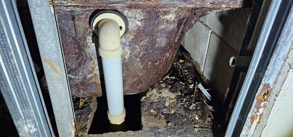 A rusty tub and drain. 