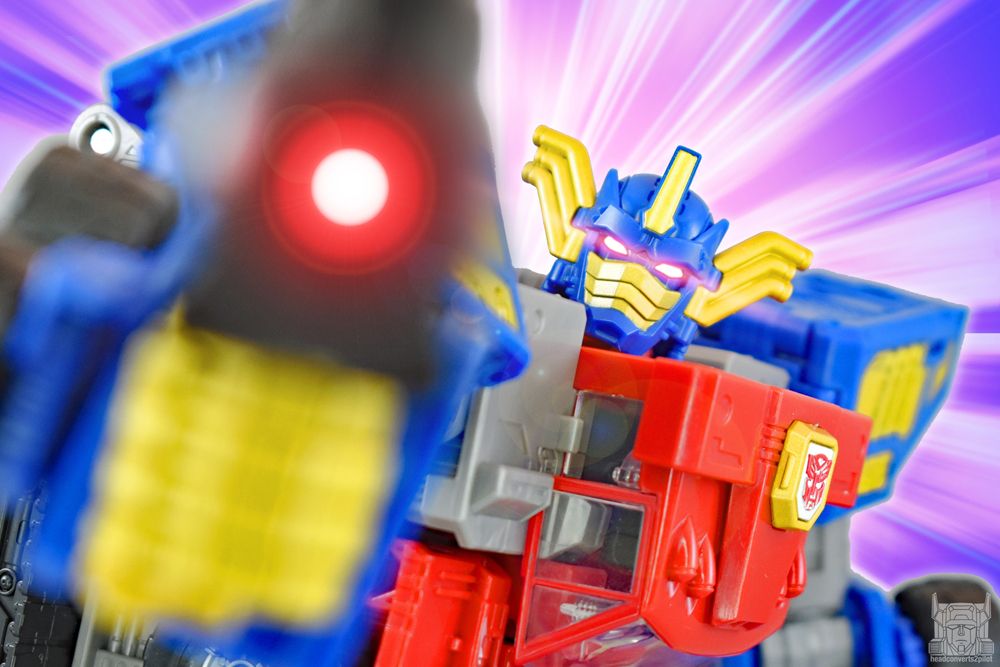 Photo edit of Legacy Armada Optimus Prime in super mode aiming his blaster.