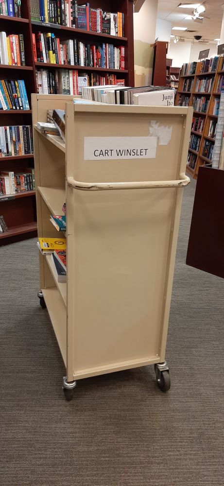a rolling book cart with a label on it reading CART WINSLET