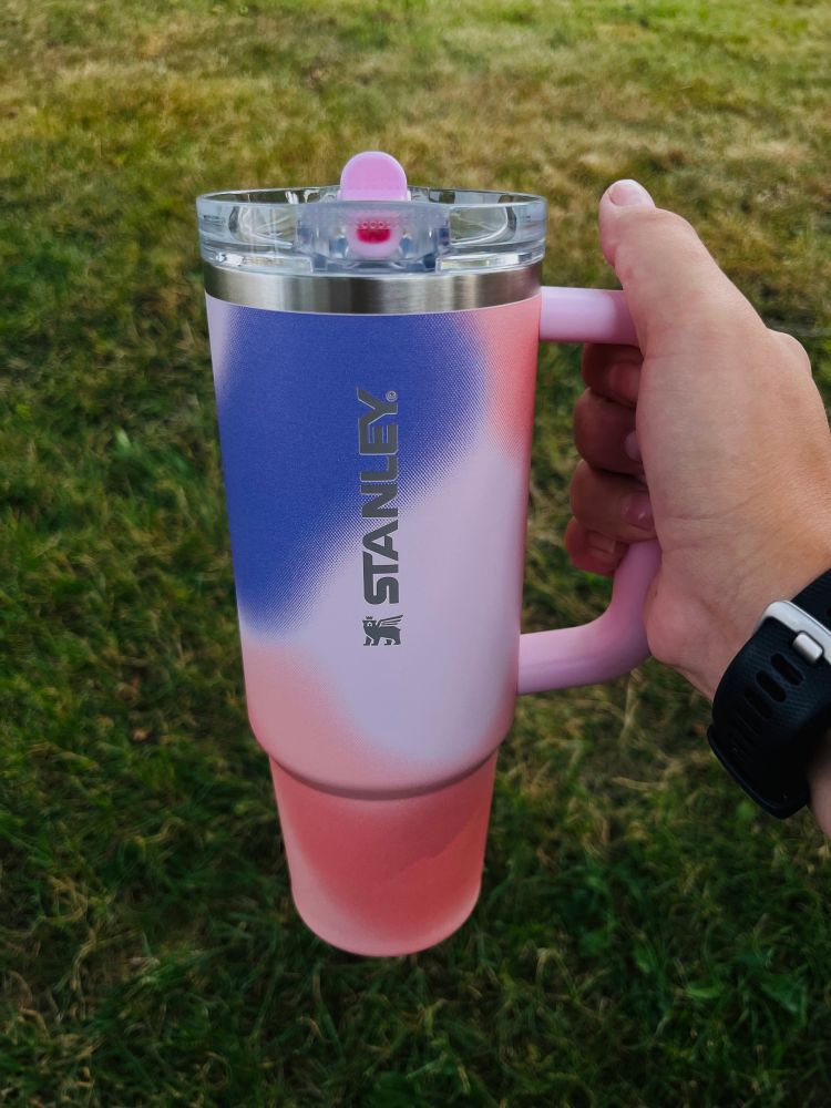 a picture of me holding my new pink and purple stanley 