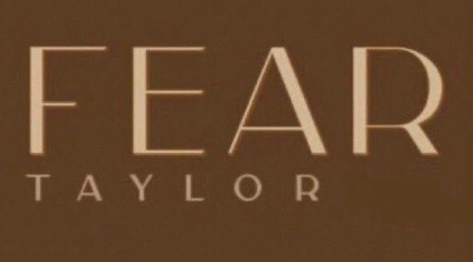 light brown lettering that says “FEAR TAYLOR” on a dark brown background 