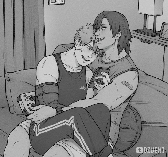 Kirishima plays a video game while Bakugo sits on his lap reading on his phone.