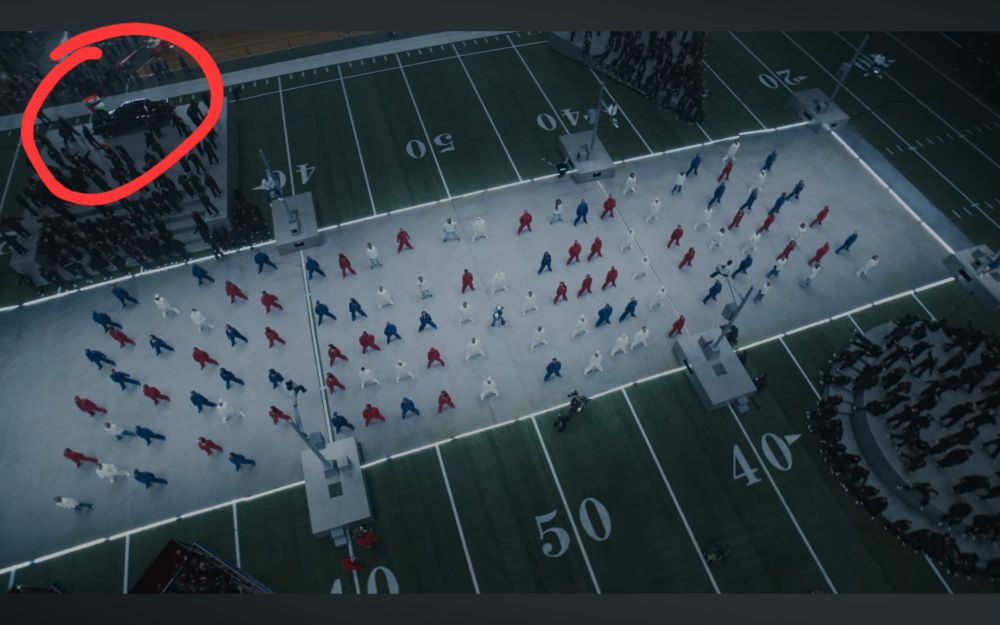 Overhead shot of the field during the halftime show, protestor clearly visible in the top right corner on top of the GNX 