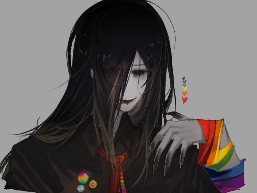 Mr. K with a pansexual, trans and intersex pin and a rainbow flag wrapped around his arm.