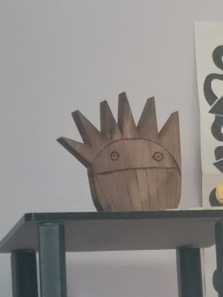 A wooden carving of a Boognish