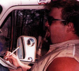 D Boon of The Minutemen is shown in the passenger seat of the tour van with a notebook and pencil.
RIP 4/1/58 - 12/22/85